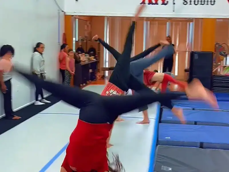 Kids performing synchronized gymnastics flips at Cirque Art Studio, North Miami Beach, FL.